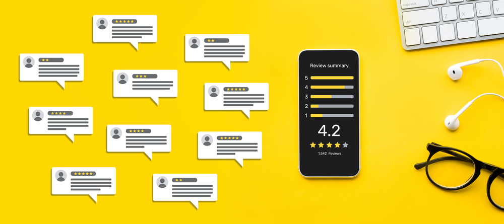A phone showing an aggregate review rating on a yellow background with mock written reviews besides it